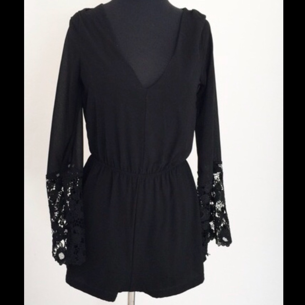 V-neck black romper w lace sleeves that bell out